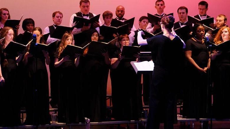 A choir wearing black performs a choral work